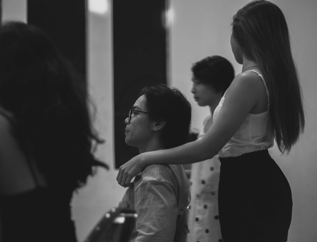 grayscale photo of woman in tank top and man in tank top
