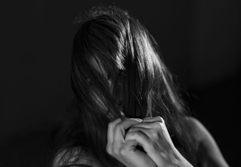 a woman with her hair blowing in the wind